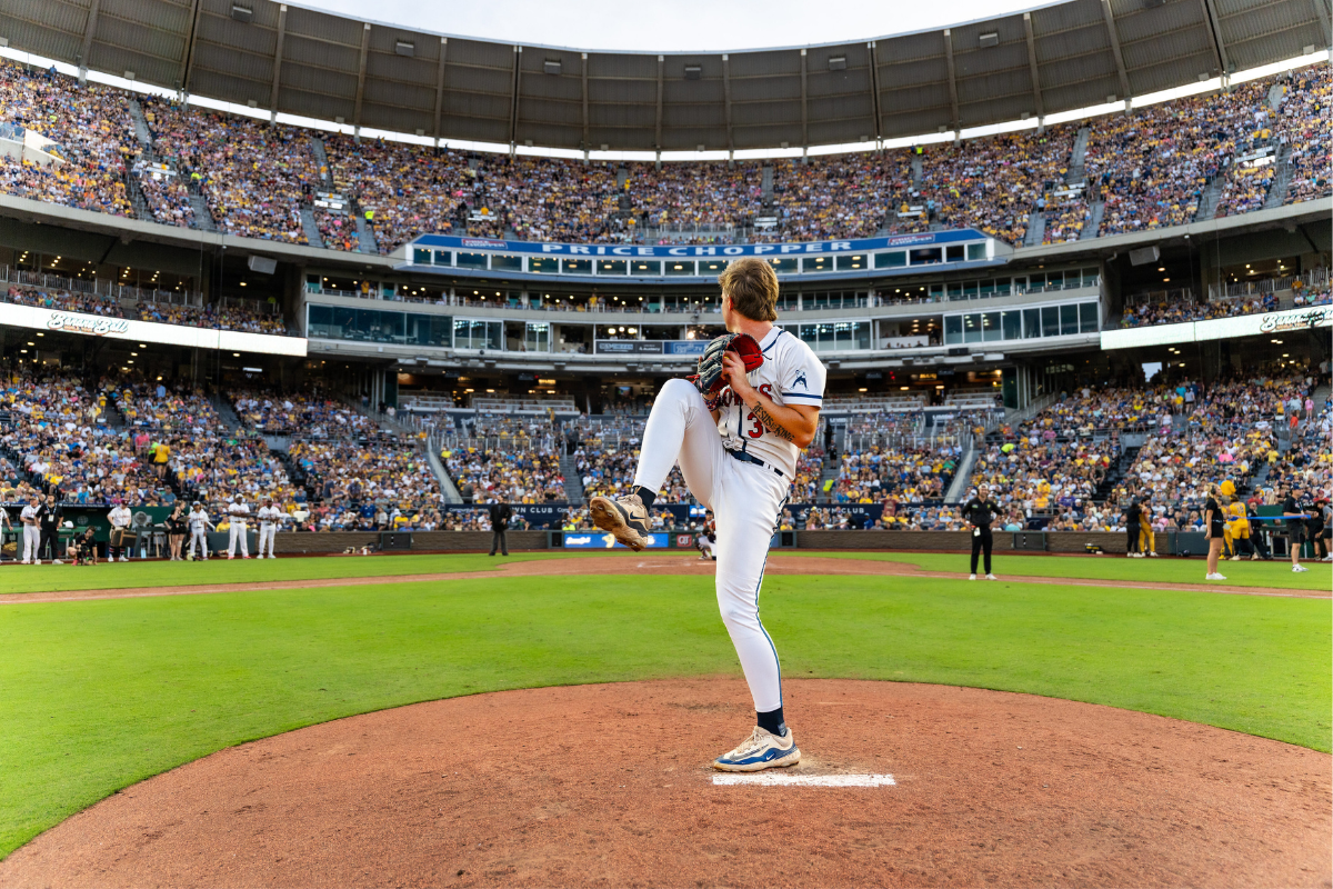 PBA Alum Daniel Foster pitches in the Banana Ball League in front of a large stadium of fans.